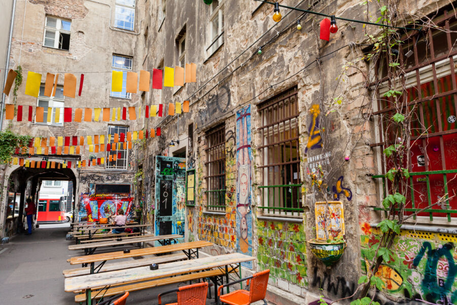 Outdoor seating at a Kreuzberg restaurant in Berlin, featuring a view of the bustling street and surrounding urban landscape