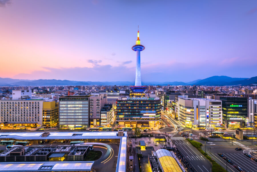 Stunning skyline of Kyoto, Japan, featuring traditional architecture and modern skyscrapers against a backdrop of mountains