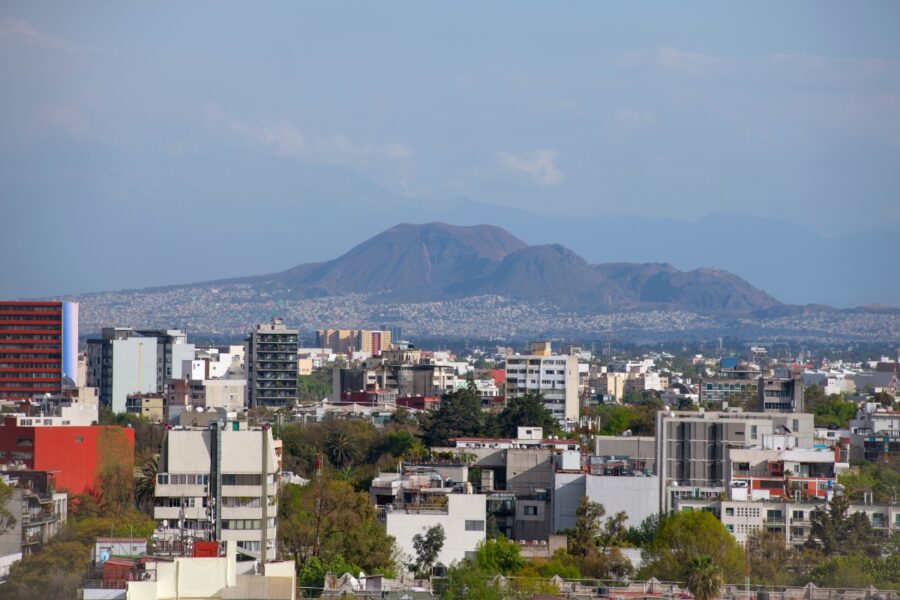 Aerial view of Tetlalmanche volcano with modern buildings in La Condesa, downtown Mexico City, showcasing urban landscape