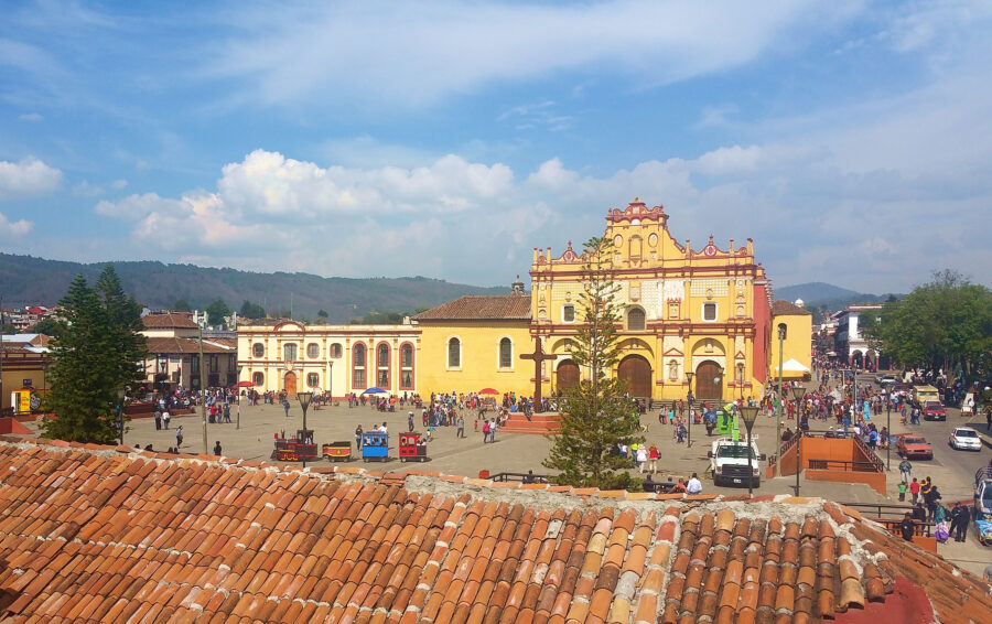 Visitors stroll in front of the baroque cathedral in La Plaza De La Paz, San Cristobal de las Casas, Chiapas
