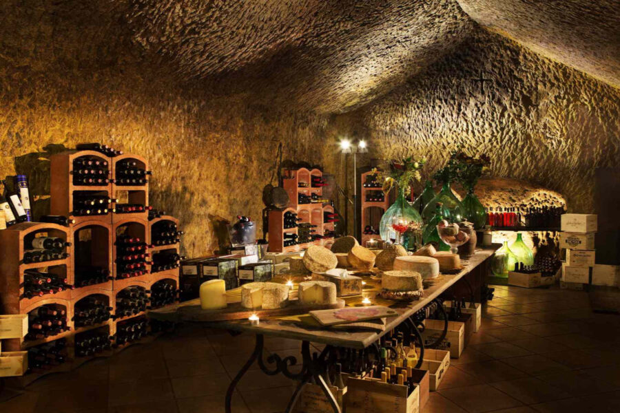 Interior view of La Taverna di San Giuseppe, showcasing rustic decor and warm lighting in a cozy dining atmosphere.
