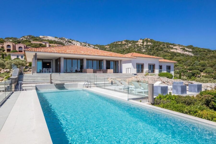 La Villa Calvi in France, perched on a hillside, offers a picturesque view of the sea.