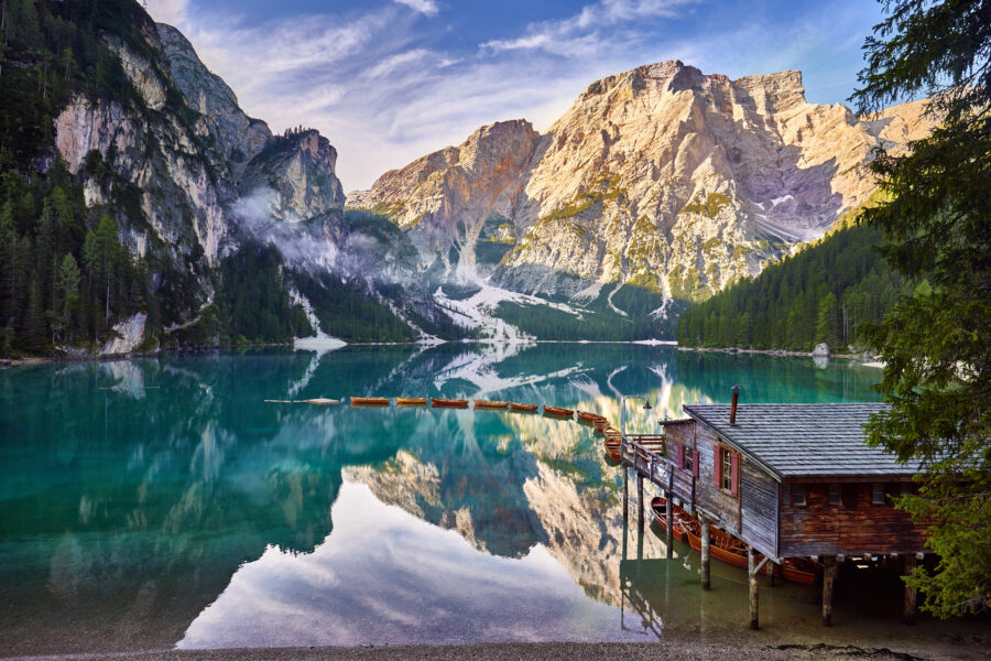 Stunning sunrise view of Lago di Braies, framed by the Dolomites in South Tyrol, Italy's Trentino Alto Adige region.
