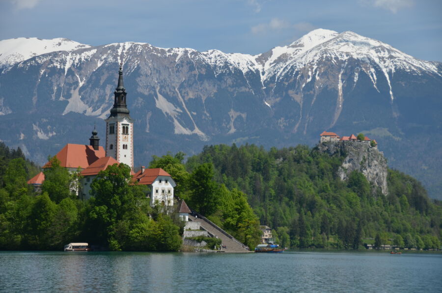 Scenic view of Lake Bled with Bled Island and its church, showcasing stunning architecture against a picturesque landscape