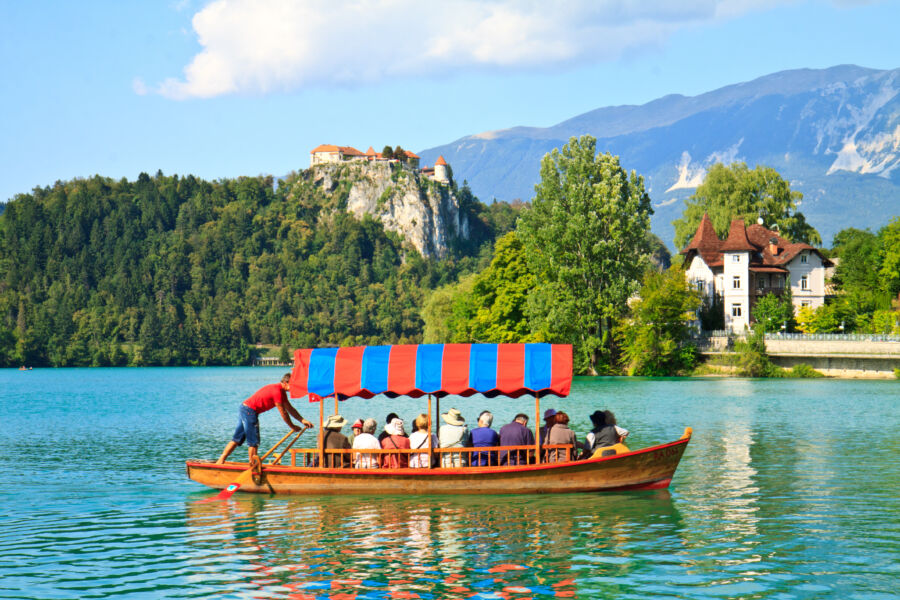 Boat tour on Lake Bled, Slovenia, highlighting the calm waters and beautiful natural surroundings of the iconic destination