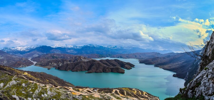 Scenic view of Lake Bovilla and surrounding mountains from a mountain summit in Albania.