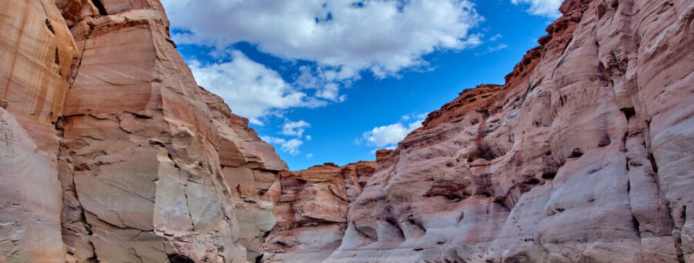 Narrow canyon with steep cliffs viewed from a boat in Glen Canyon National Recreation Area, Lake Powell, Arizona.