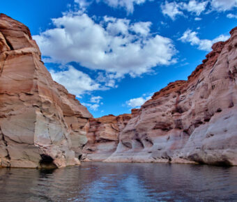 Narrow canyon with steep cliffs viewed from a boat in Glen Canyon National Recreation Area, Lake Powell, Arizona.