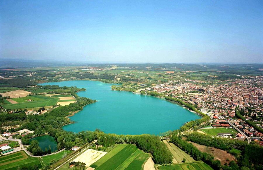 Aerial view of Jarun Lake, lush landscape, vibrant fields, and picturesque town.