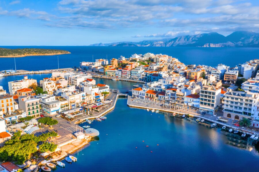 Lake Voulismeni in Agios Nikolaos, Crete with colorful buildings and marina, Greece.