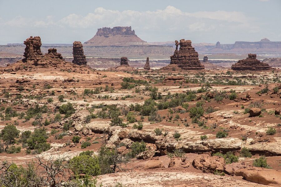 Scenic view of Monument Valley, Utah, featuring towering sandstone buttes against a vibrant desert backdrop.