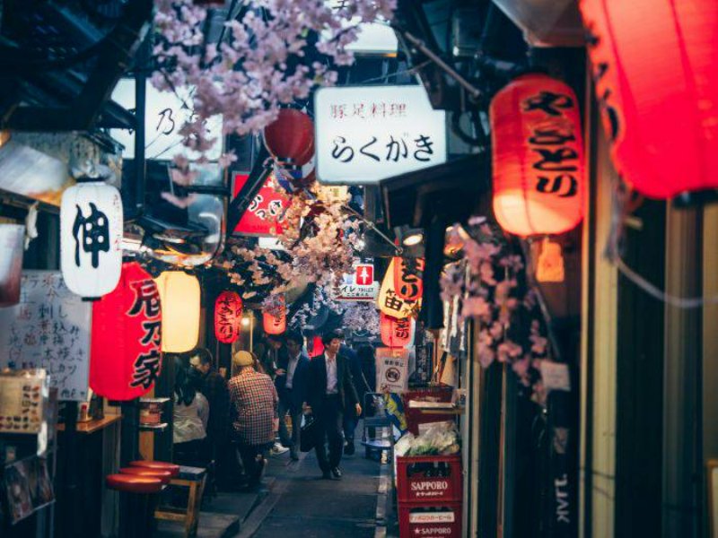 Omoide Yokocho lantern-lined izakaya alley in Tokyo at night.