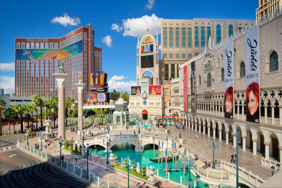 Las Vegas Venetian Resort canal scene with gondolas, architecture, and bustling tourists.