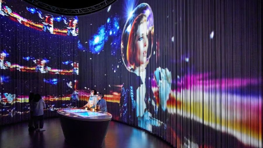 Large screen features a woman in space and a man in a suit, highlighting the Lavazza Museum Exhibit.


