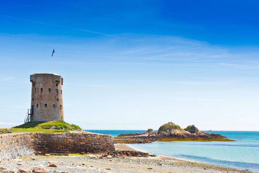 Le Hocq Tower and the surrounding common bask in sunlight on a warm summer day on Jersey's south shore, Channel Islands.