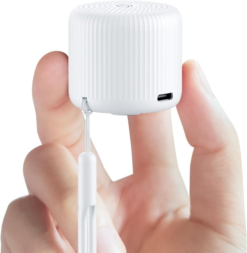 Hand with a small white LEICEX Mini Travel Sound Machine speaker, showcasing its portable design.