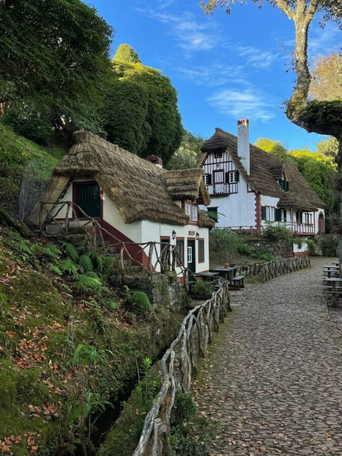Scenic path leads to a charming thatched cottage nestled in the countryside along Levada do Caldeirão Verde, Madeira.