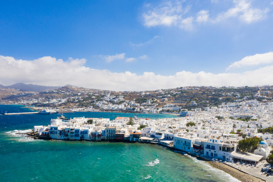 Aerial view of Little Venice, Mykonos with whitewashed buildings and the sparkling Mediterranean Sea.