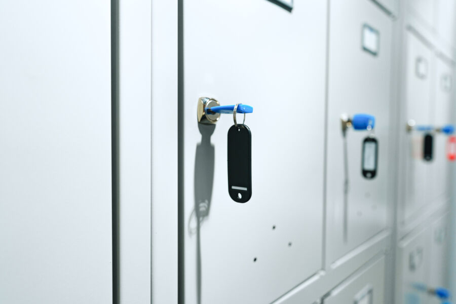 Public facility gray locker with a key for secure storage and safety