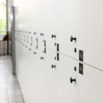 Multiple white lockers arranged in neat rows, creating a uniform appearance