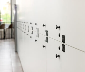 Multiple white lockers arranged in neat rows, creating a uniform appearance