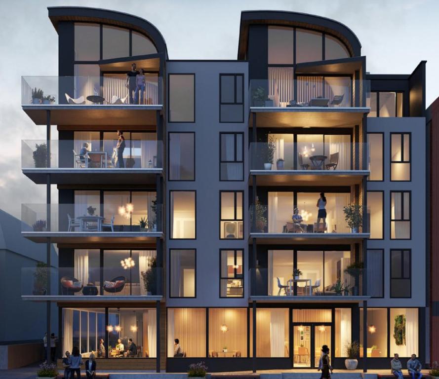 Lofoten Suites Apartments, featuring a contemporary design with a mix of brick and glass elements.