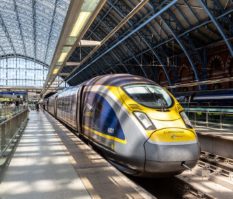 The modern Eurostar bullet train stands at a London platform, showcasing its streamlined design.