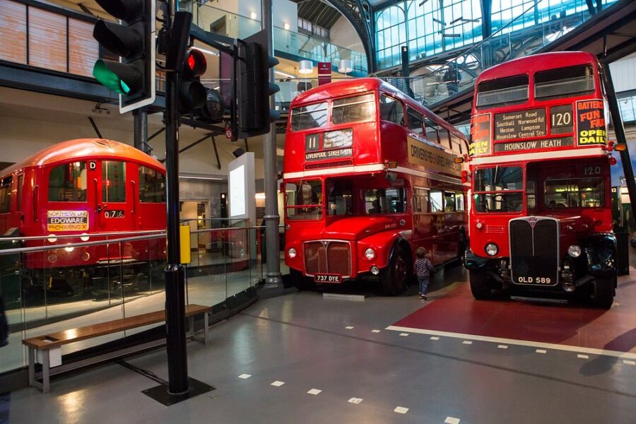 Two red double-decker buses parked inside the London Transport Museum in London, UK.