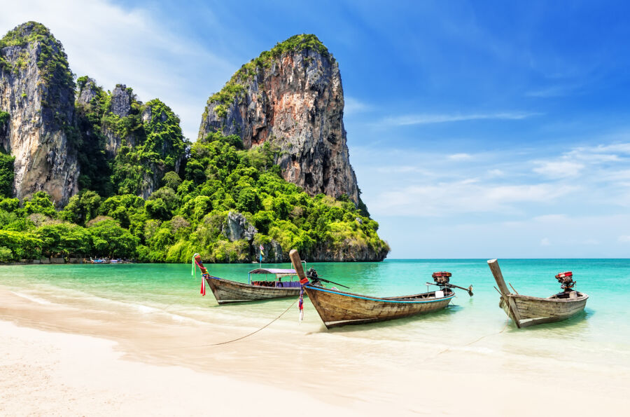 Thai wooden longtail boat anchored in Phuket, featuring a colorful design typical of the region's traditional fishing vessels