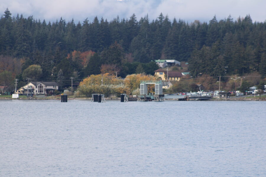 Distant view of Lopez Island in the San Juan Islands, showcasing lush greenery and serene waters.
