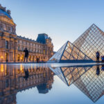 View of famous Louvre Museum with Louvre Pyramid at evening