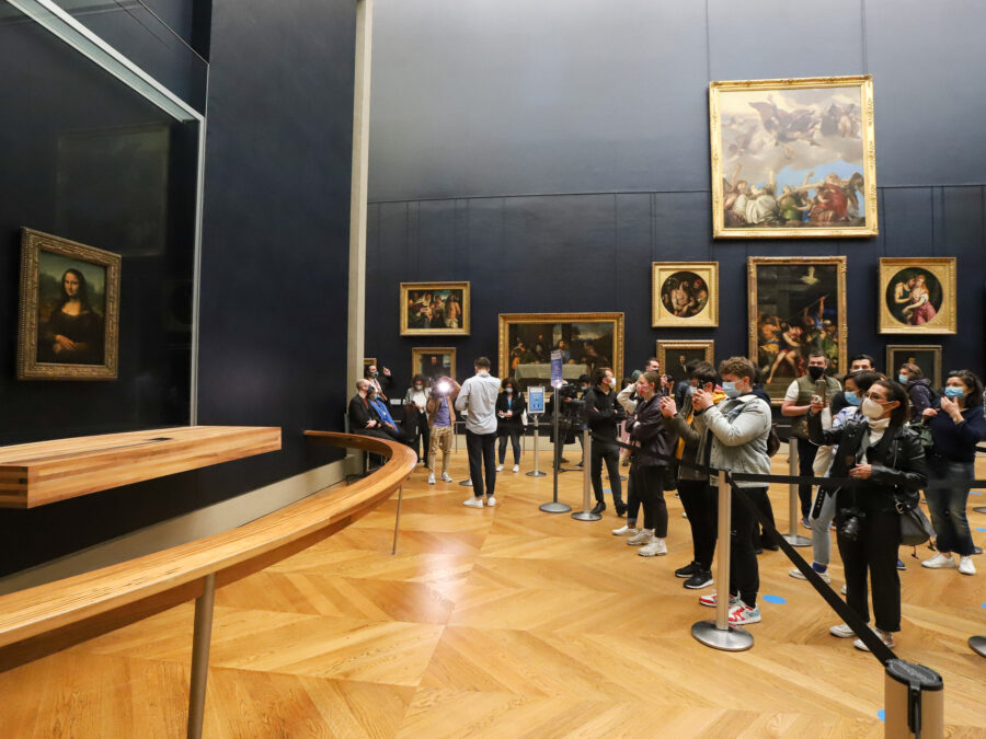 Visitors photograph the Mona Lisa as the Louvre reopens post-lockdown.