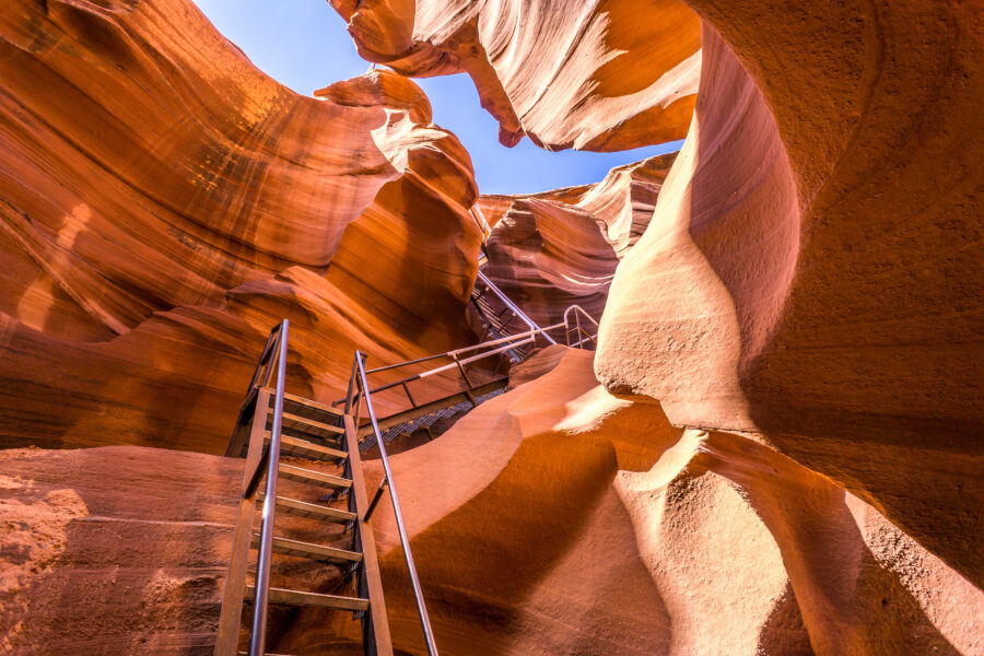 Lower Antelope Canyon in Arizona features stunning, narrow passageways with vibrant red and orange sandstone formations.
