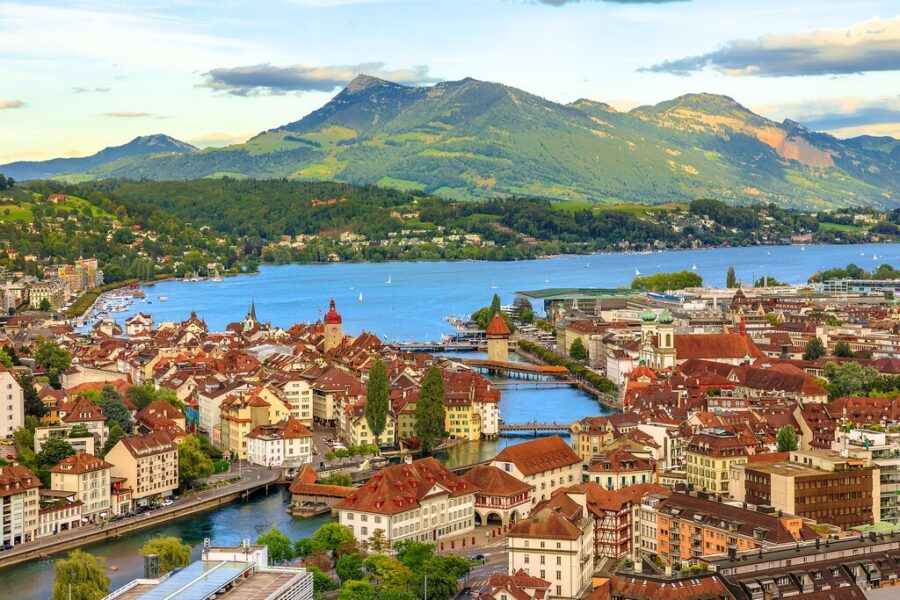 Aerial view of Lucerne, Switzerland with Swiss Alps and lake, featuring traditional architecture.