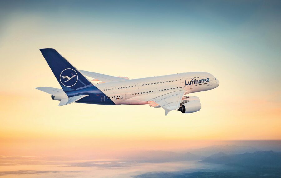 Lufthansa Airbus A380 soaring at sunset, symbolizing air travel, freedom, and adventure.