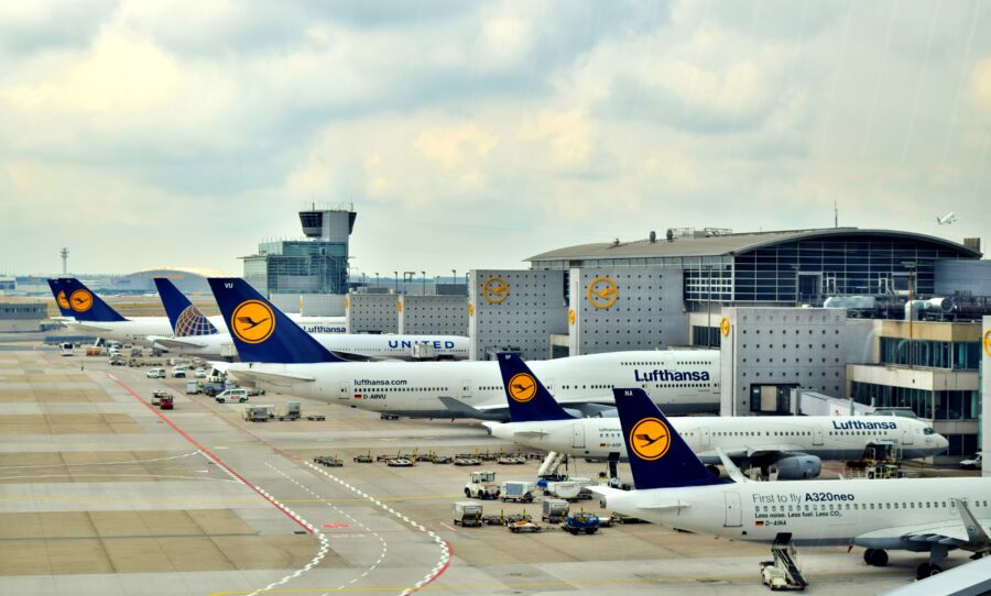 Aerial view of Lufthansa planes parked at Frankfurt Airport, the airline's largest hub, showcasing multiple aircraft on the tarmac