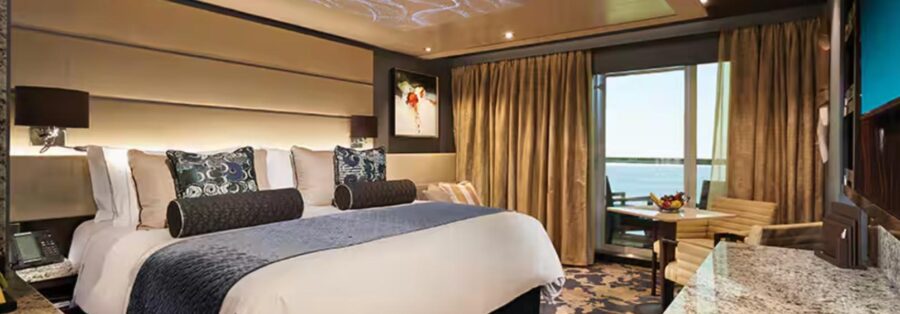Luxurious hotel room with king bed, elegant decor, scenic view, and cozy seating area.
