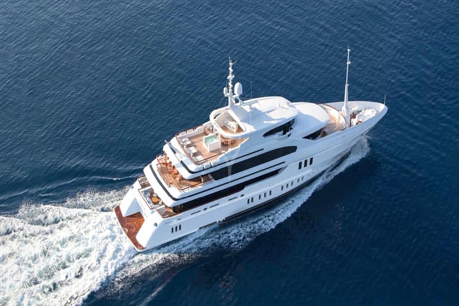 Luxurious modern yacht cruising on deep blue waters with elegant design and multiple decks.