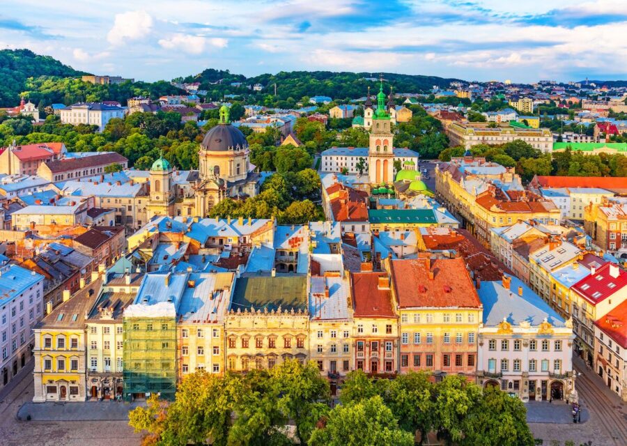Aerial view of Lvivs historical architecture, green dome, and vibrant cityscape.