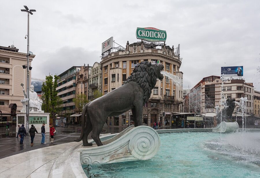 City fountain with a prominent lion statue at its center, situated in Macedonia Square.