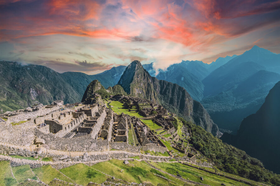 Iconic Machu Picchu ruins at sunset, showcasing Inca architecture amid stunning Andean mountain scenery.