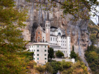 The Madonna della Corona Sanctuary in Verona, Italy, is a picturesque church set against dramatic cliffs and scenic views