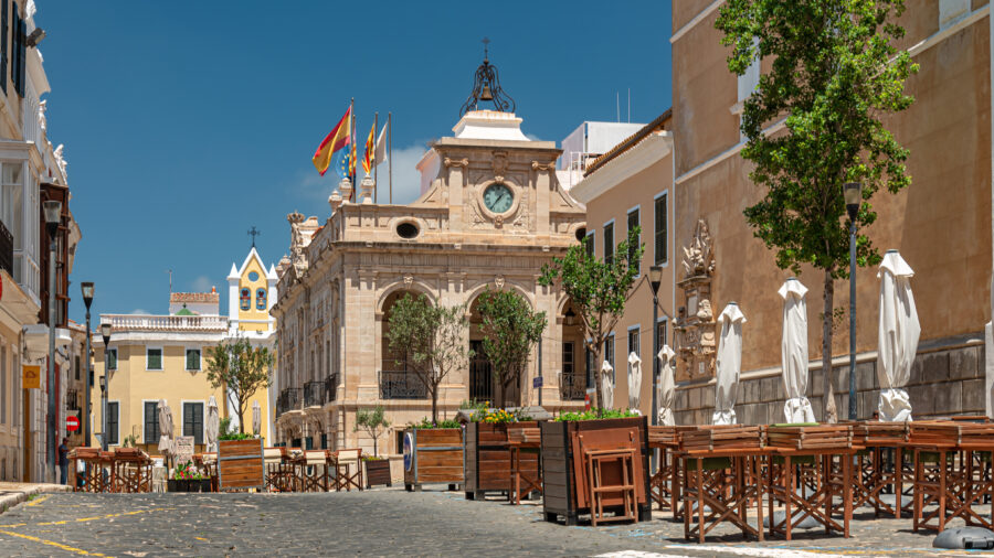 Mahon Town Hall, a historic building in Menorca, Spain, featuring classic architecture and a prominent clock tower.