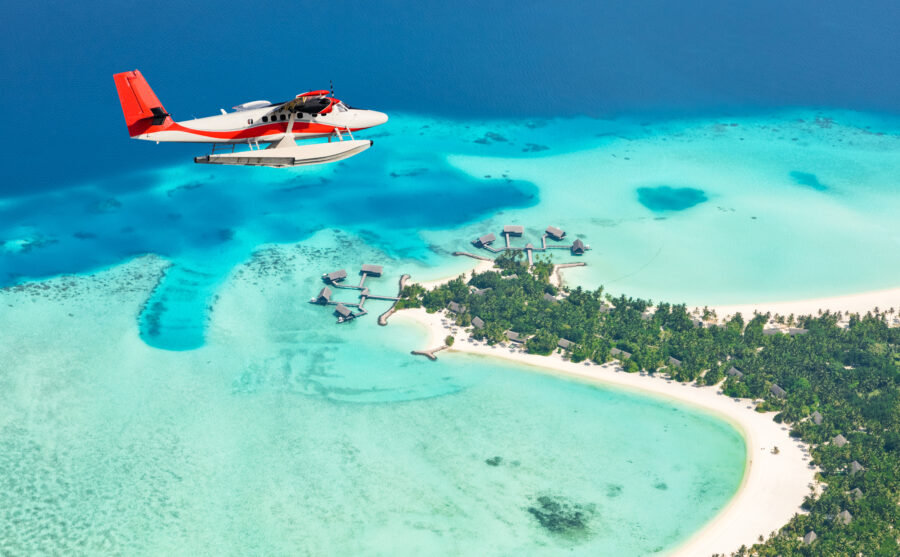 Seaplane glides over the Maldives islands, showing off turquoise waters and white sandy beaches