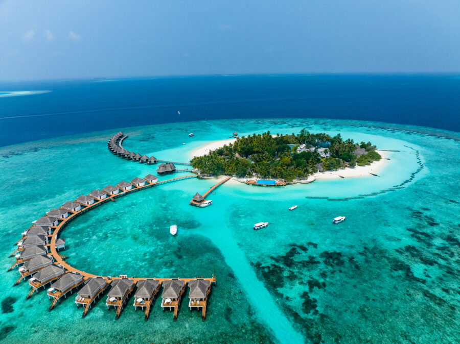 Aerial view of Thulhagiri Island Resort with water bungalows in North Malé Atoll, Maldives