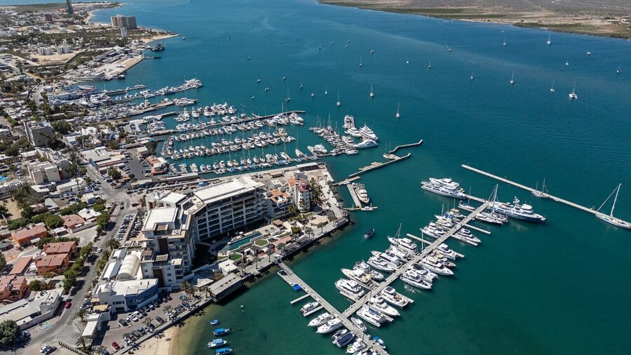 Aerial view of Malecón La Paz in Mexico, showcasing a marina filled with various boats docked along the waterfront.