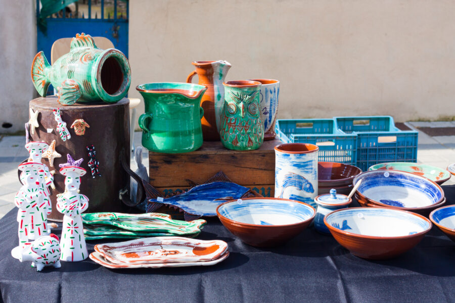 Colorful ceramic pottery available for purchase at a bustling market in Esporles, Mallorca, Spain