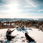 Man with pet dog at a winter park