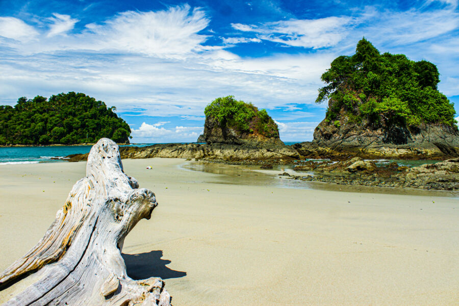 Scenic outlook from Manuel Antonio National Park, featuring lush greenery and rocky formations