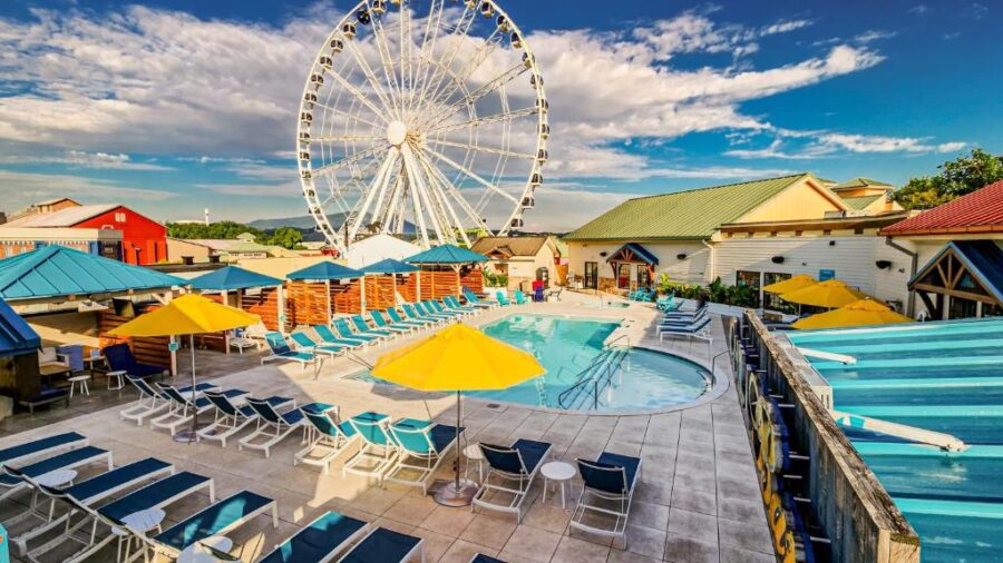 The ferris wheel towers over a clear blue pool at Margaritaville Island Hotel, highlighting the resort's fun and relaxing vibe.